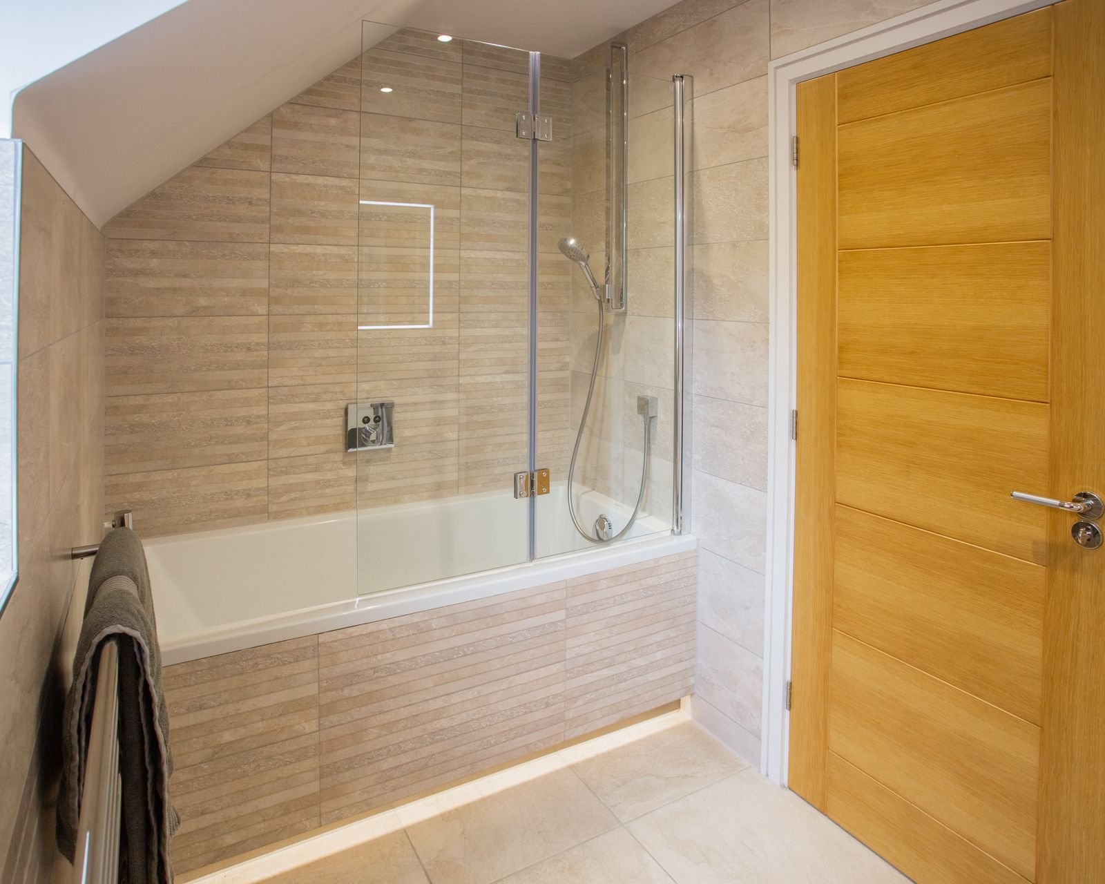 A newly fitted bathroom with a walk-in glass shower